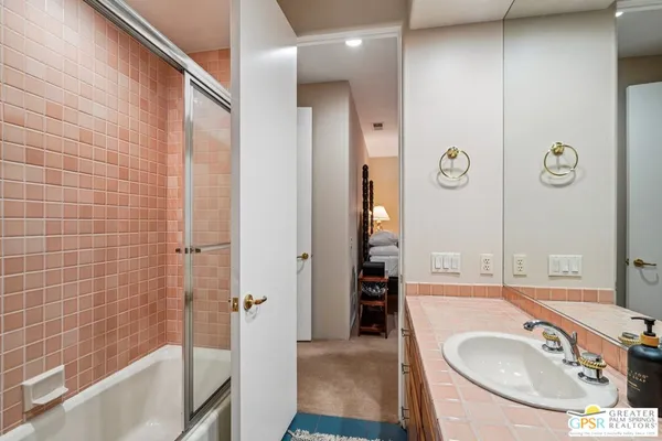 a bathroom with a tub sink and shower