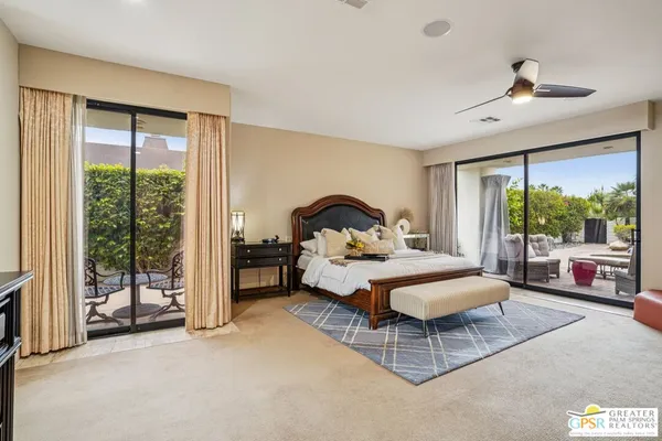 a bedroom with a bed and large window