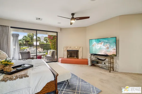 a bedroom with furniture and a flat screen tv