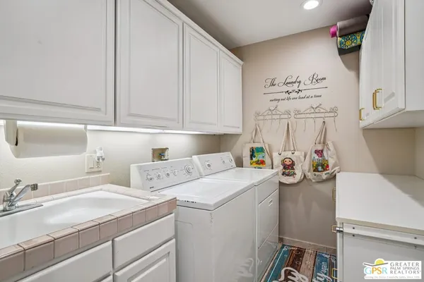 a view of storage and utility room with washer and dryer