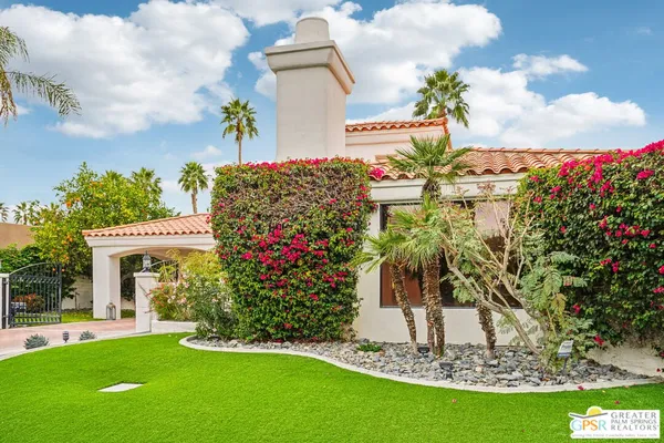 a view of a house with a yard and garden
