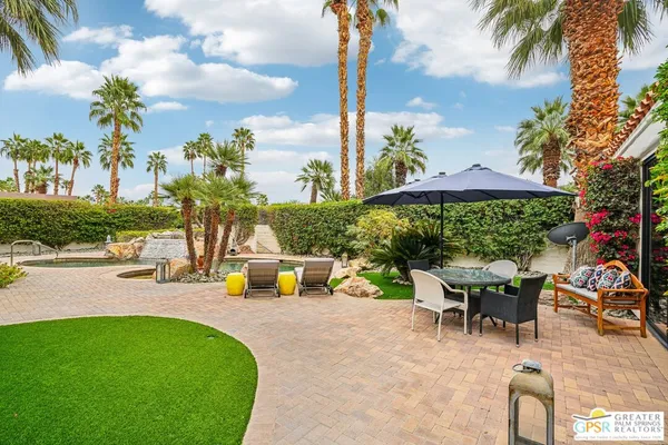 an outdoor space with furniture and garden