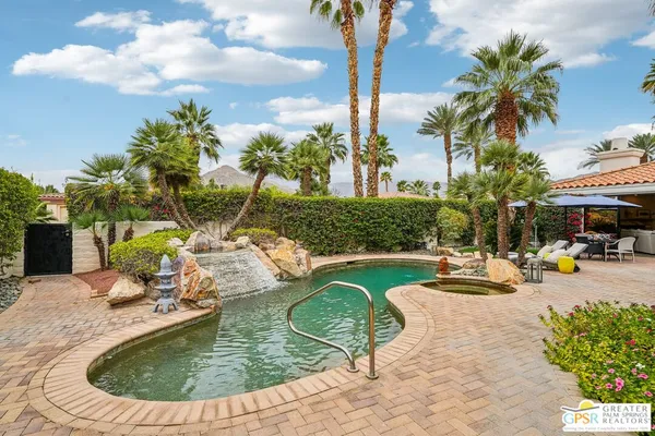 a view of a swimming pool with a lounge chair