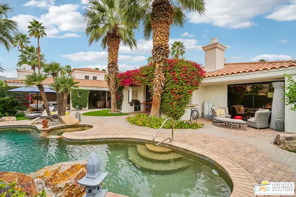 a swimming pool with outdoor seating yard and barbeque oven