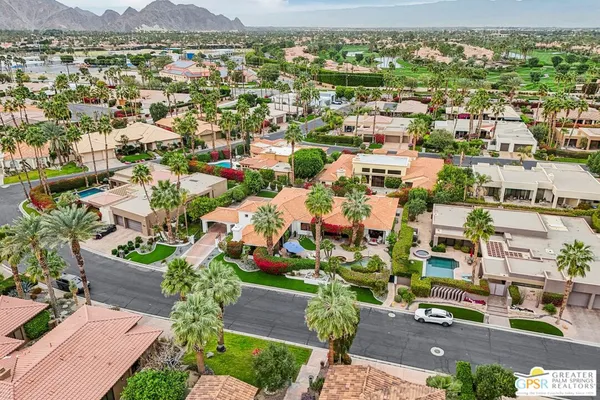 an aerial view of residential houses with outdoor space and mountain view