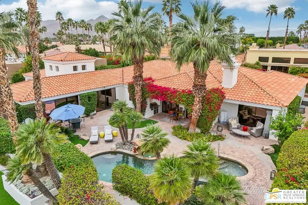 an aerial view of a house with swimming pool garden and patio