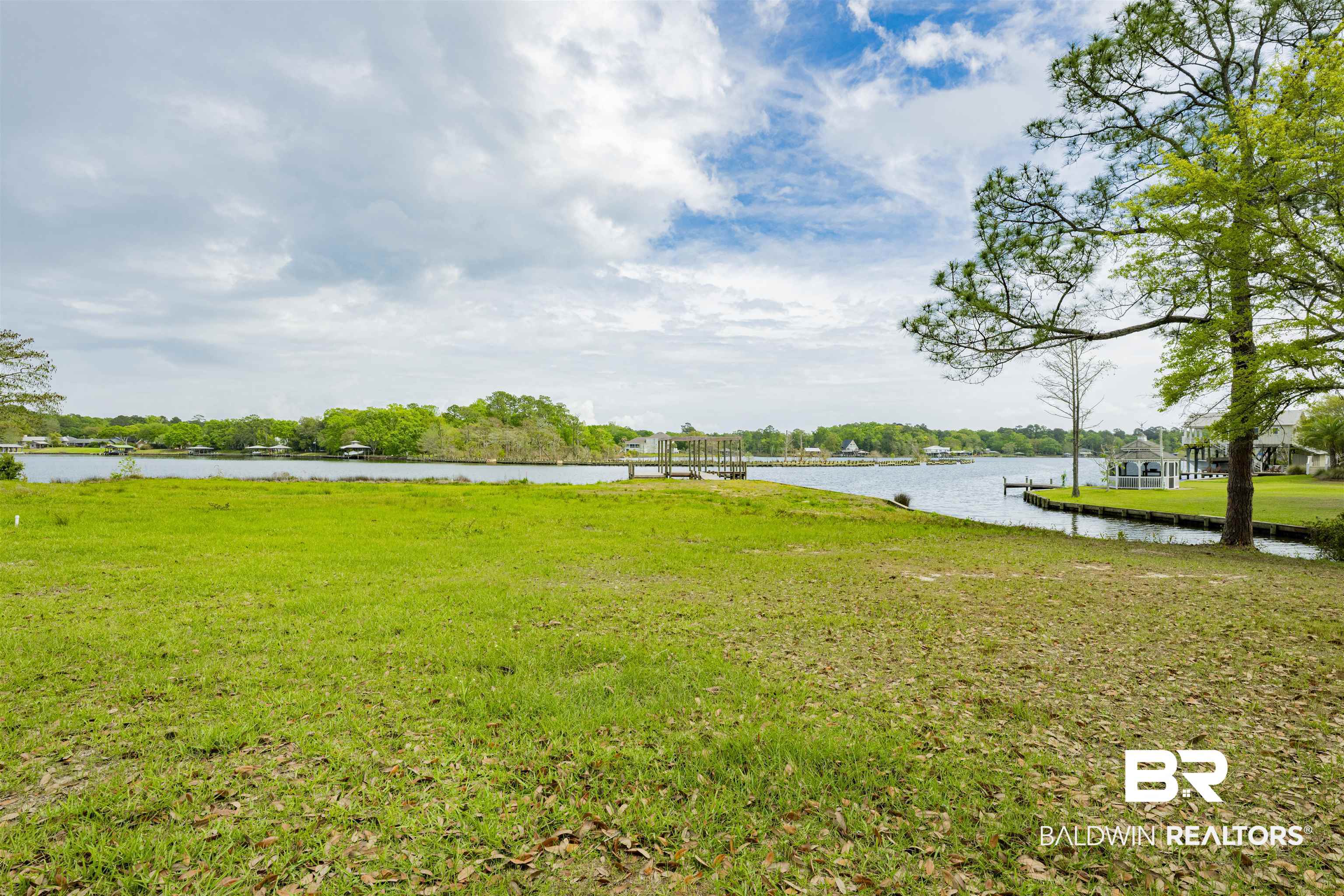 0 South Windsor Road South Theodore, AL 36582 - Photo 14 of 22 View of green lawn with a water view and a boat dock