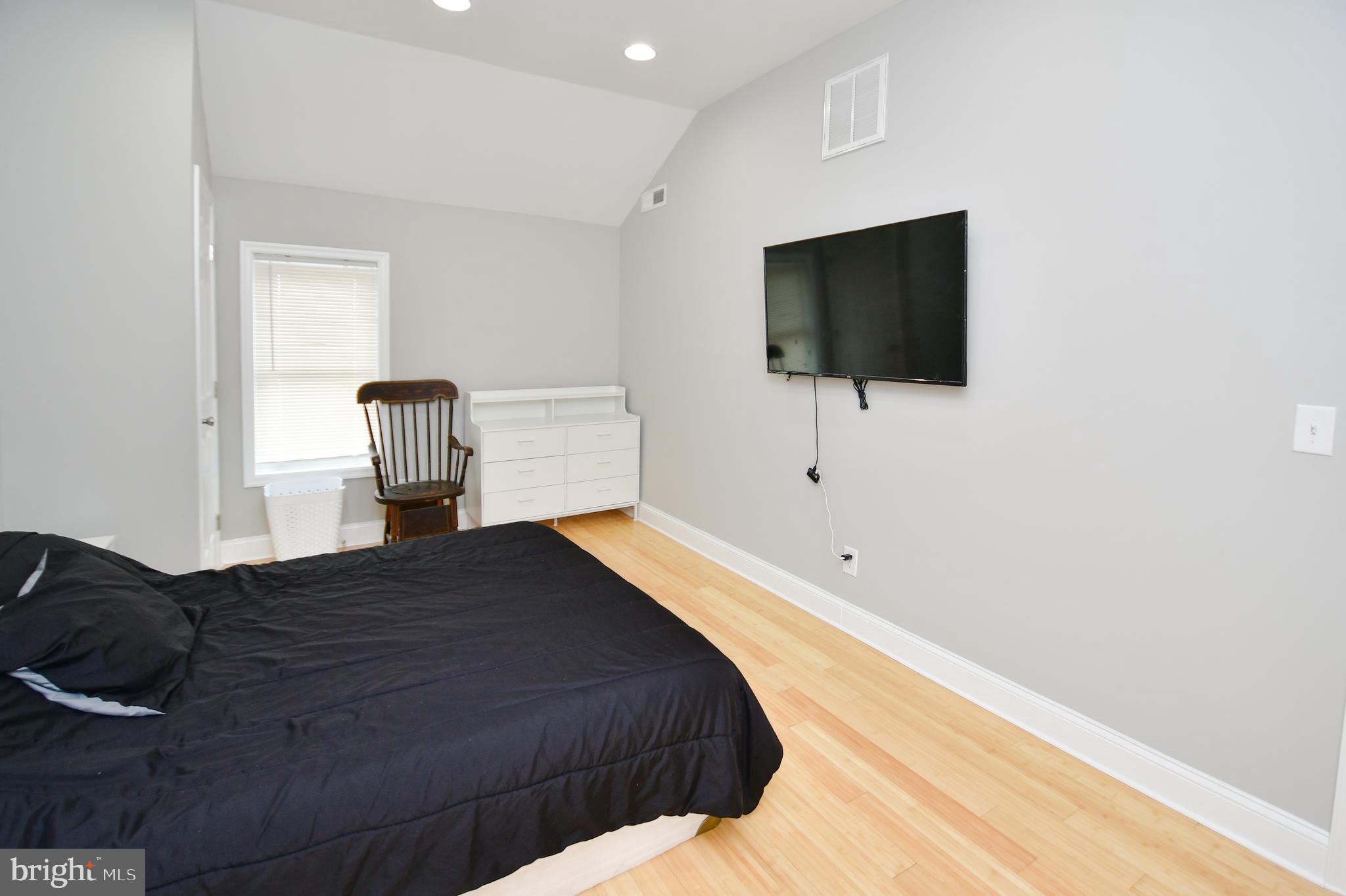 5934 Conover Road Taneytown, MD 21787 - Photo 18 of 38 a bedroom with a bed and a flat screen tv