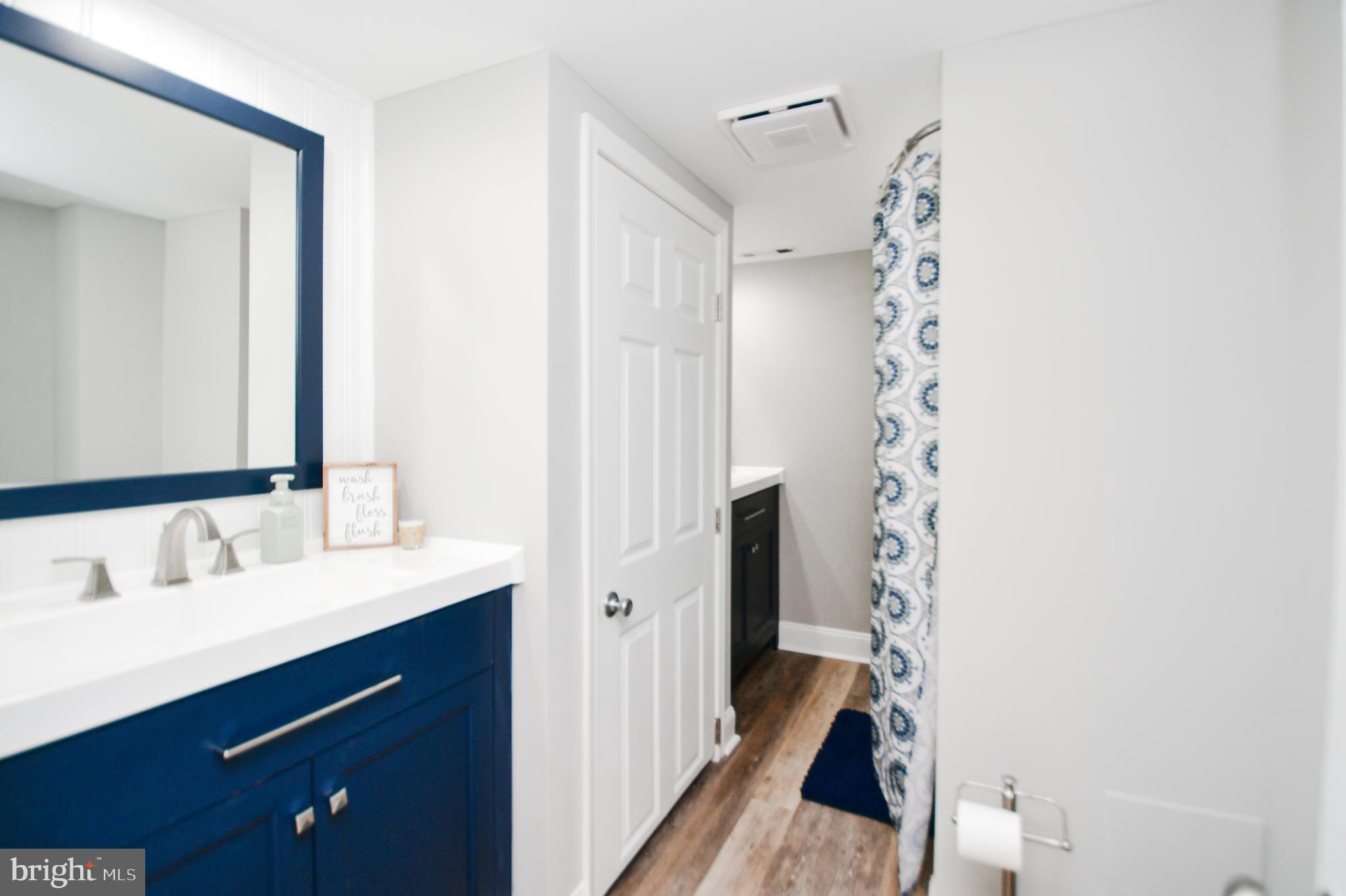 5934 Conover Road Taneytown, MD 21787 - Photo 23 of 38 a bathroom with a sink and a mirror