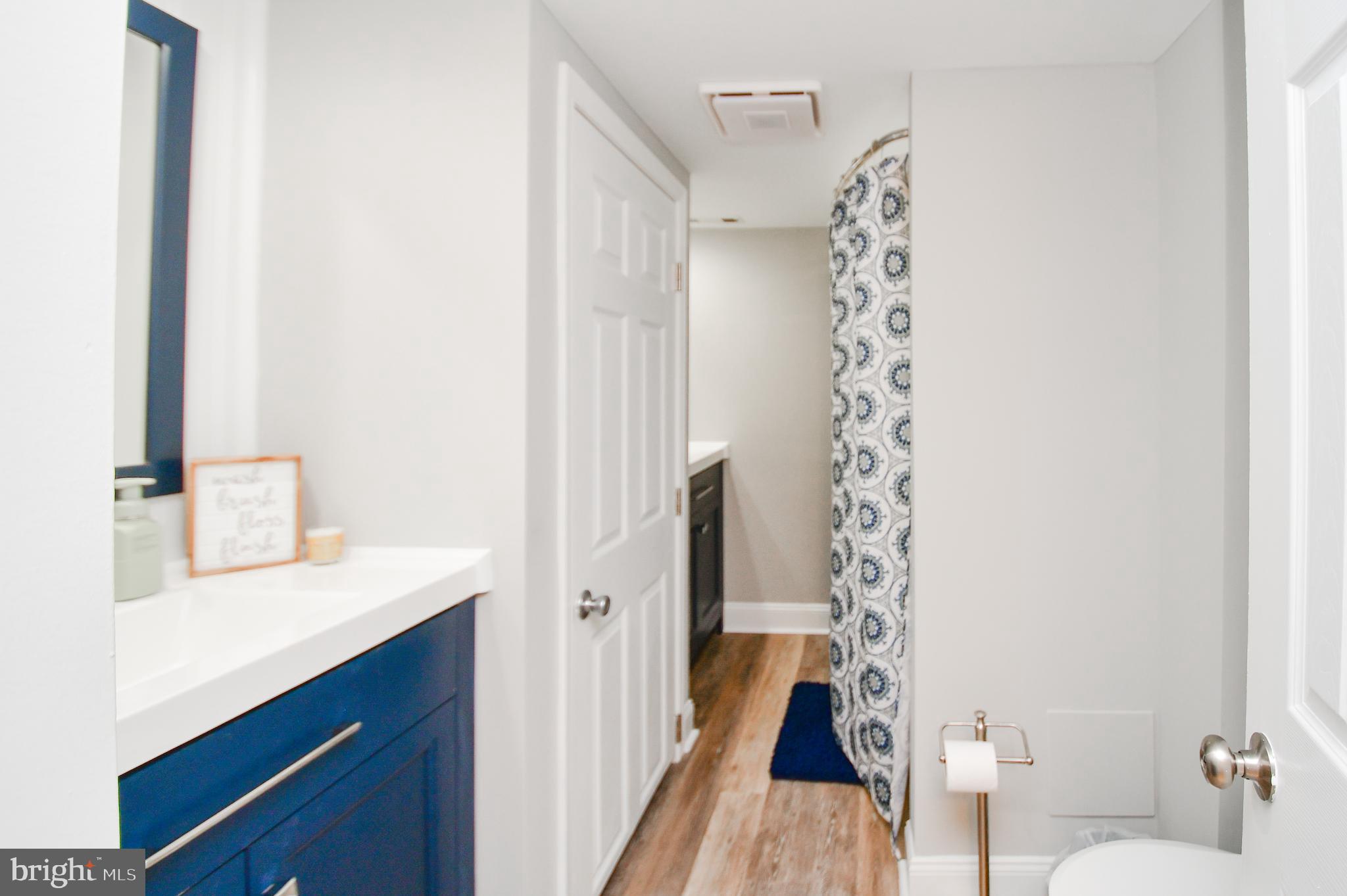 5934 Conover Road Taneytown, MD 21787 - Photo 24 of 38 a bathroom with a sink and mirror with toilet
