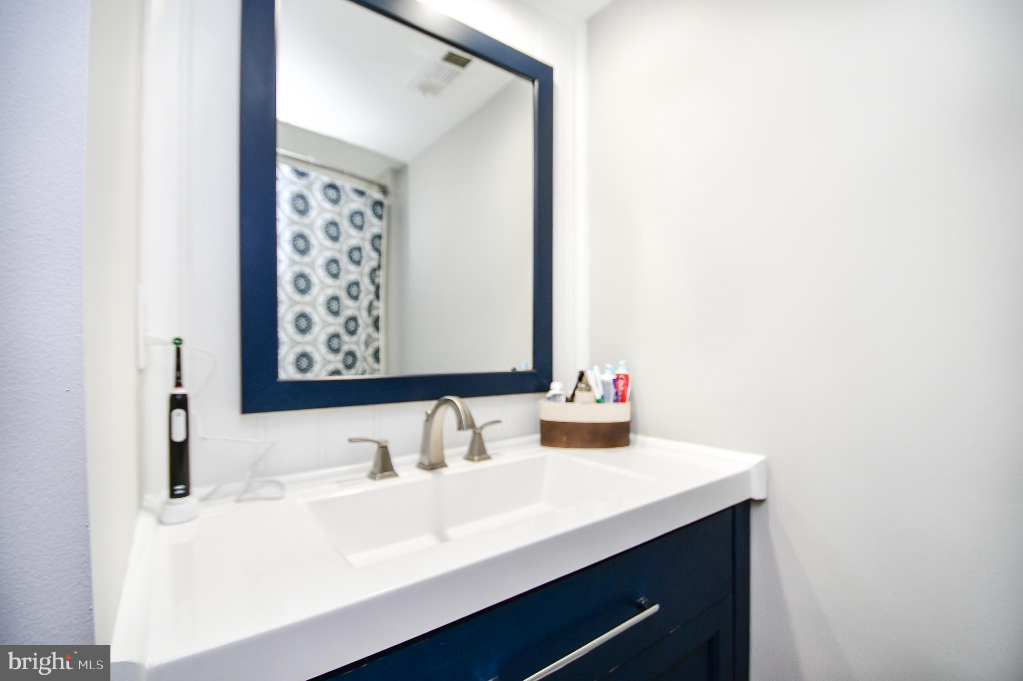 5934 Conover Road Taneytown, MD 21787 - Photo 25 of 38 a bathroom with a sink and a mirror