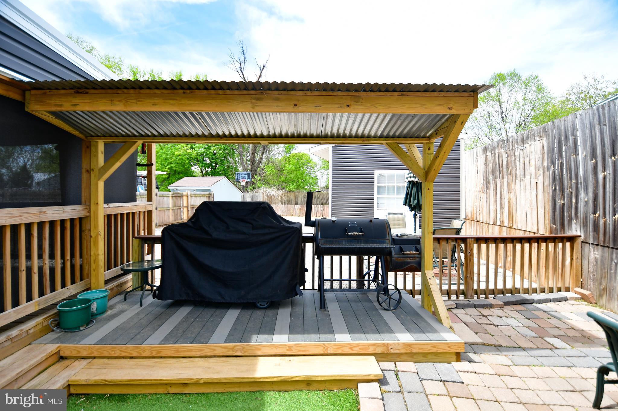 5934 Conover Road Taneytown, MD 21787 - Photo 30 of 38 a view of a patio with table and chairs floor to ceiling window with wooden floor