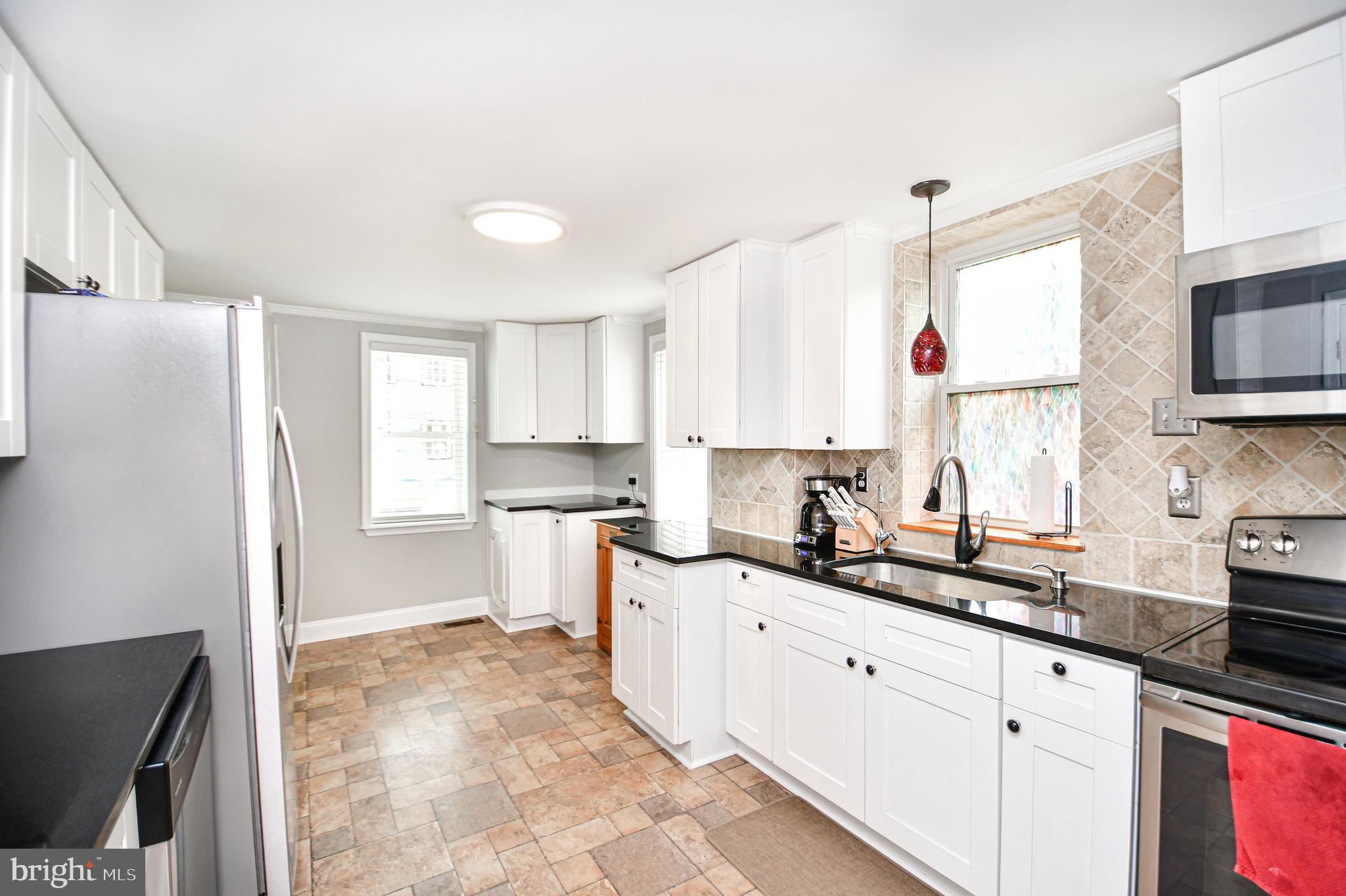 5934 Conover Road Taneytown, MD 21787 - Photo 3 of 38 a kitchen with granite countertop a sink a window stainless steel appliances and cabinets