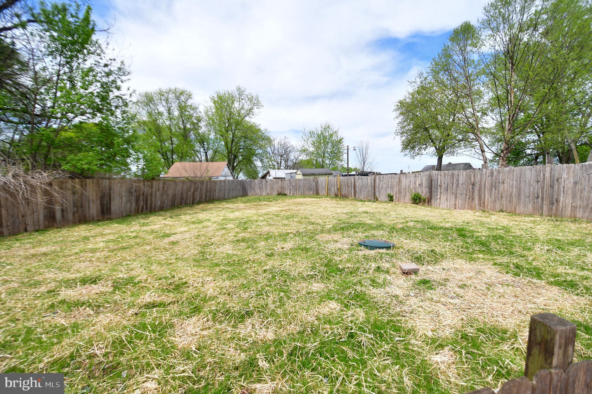 5934 Conover Road Taneytown, MD 21787 - Photo 38 of 38 a view of a backyard with a large tree and wooden fence
