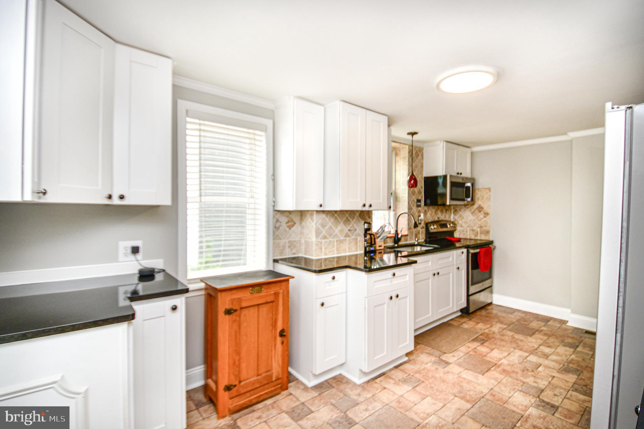 5934 Conover Road Taneytown, MD 21787 - Photo 4 of 38 a kitchen with stainless steel appliances granite countertop a sink stove and cabinets