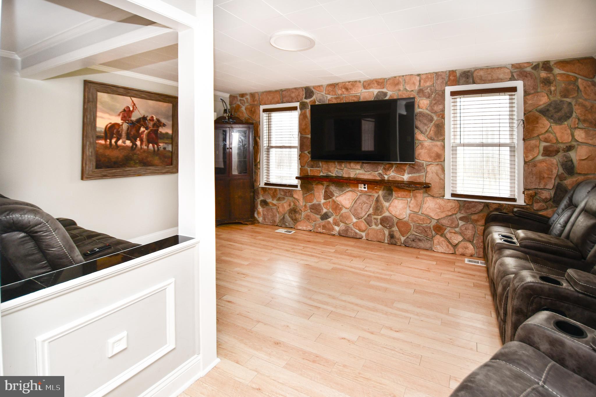 5934 Conover Road Taneytown, MD 21787 - Photo 5 of 38 a living room with furniture and a flat screen tv