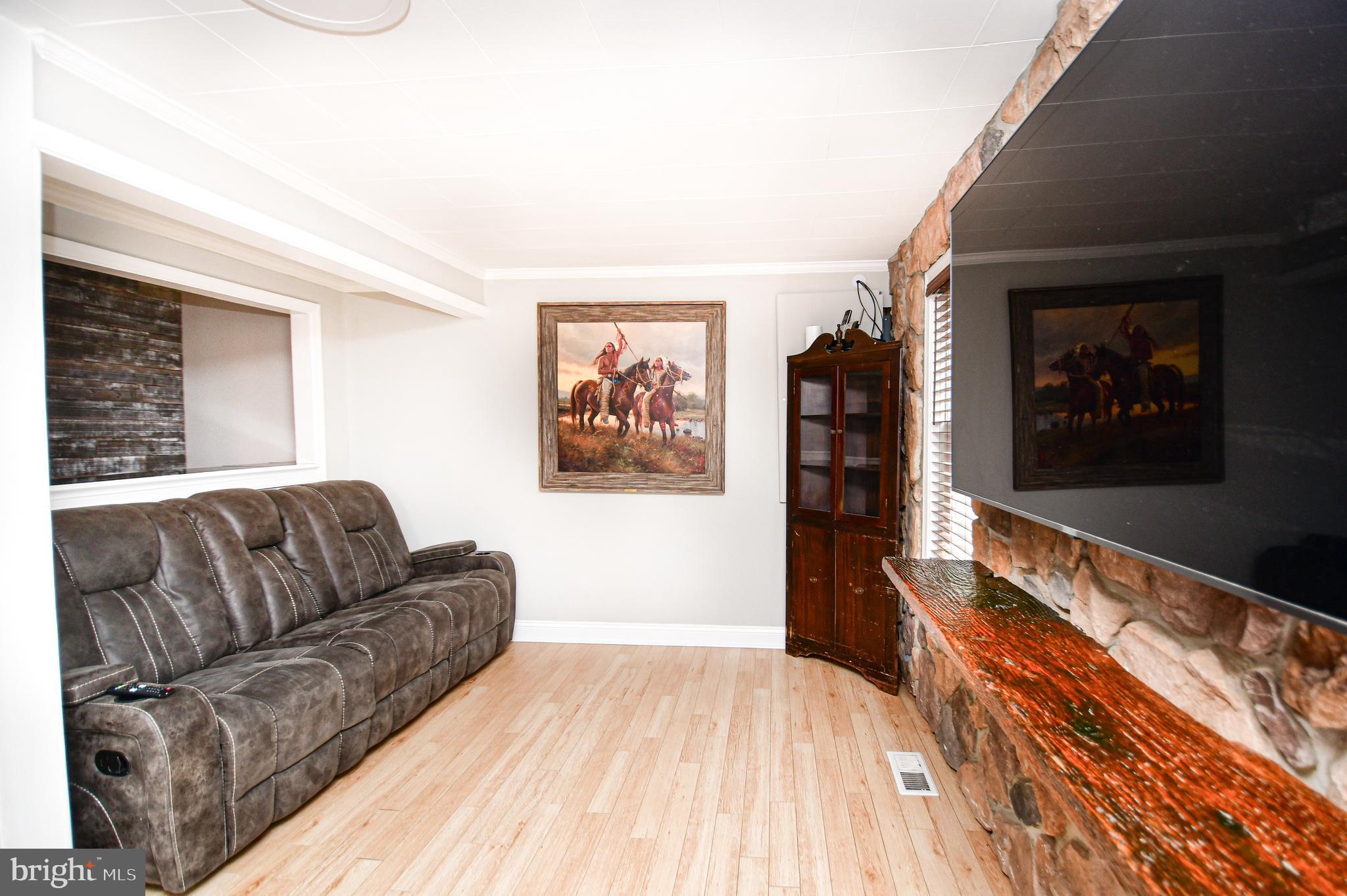 5934 Conover Road Taneytown, MD 21787 - Photo 7 of 38 a living room with furniture and a flat screen tv