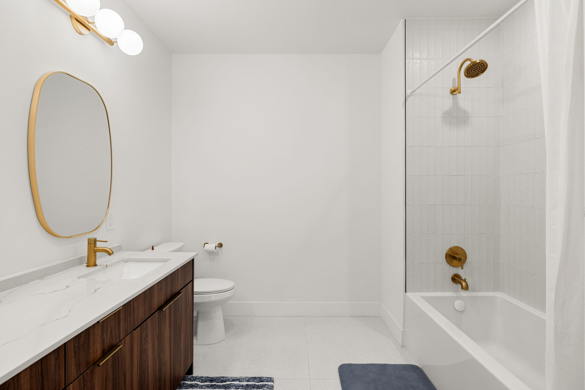 1701 Simond Avenue, Unit 612 Austin, TX 78723 - Photo 20 of 40 Contemporary bathroom featuring a dark wood-finish vanity with a white countertop and undermount sink