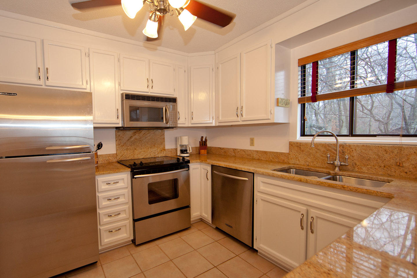 645 Monte Vista Road, Unit 103 Union Hall, VA 24176 - Photo 7 of 32 a kitchen with stainless steel appliances granite countertop a stove a sink and a microwave