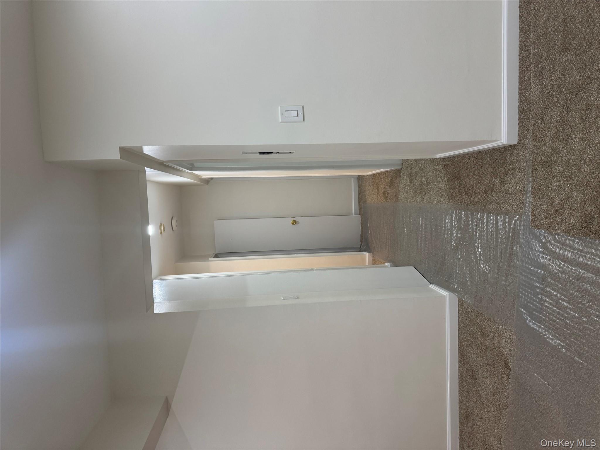 666 Shore Road Long Beach, NY 11561 - Photo 8 of 22 Hall with dark carpet and baseboards