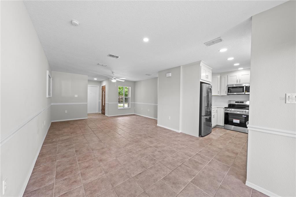 750 West New Nolte Road St. Cloud, FL 34769 - Photo 15 of 59 a view of a kitchen with refrigerator and an empty room