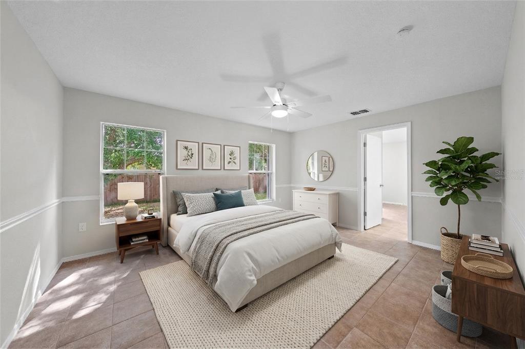 750 West New Nolte Road St. Cloud, FL 34769 - Photo 25 of 59 a bedroom with a large bed and a potted plant