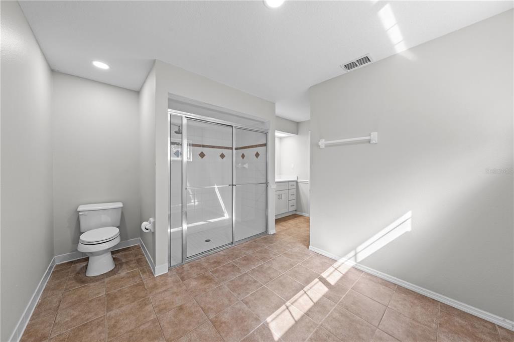 750 West New Nolte Road St. Cloud, FL 34769 - Photo 30 of 59 a bathroom with a toilet and a shower