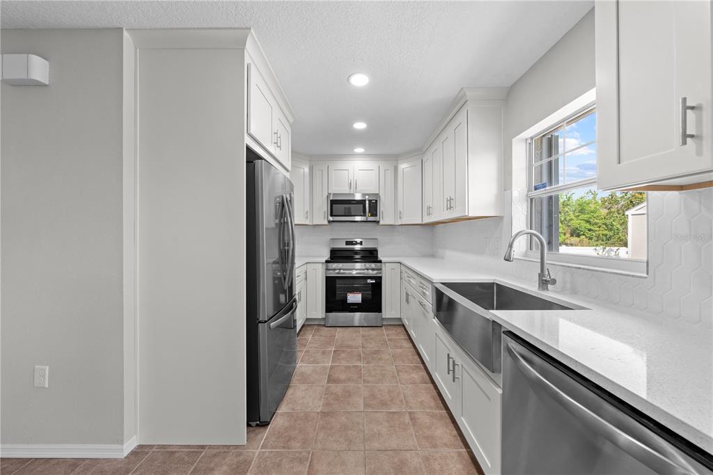 750 West New Nolte Road St. Cloud, FL 34769 - Photo 34 of 59 a large kitchen with a large window and stainless steel appliances