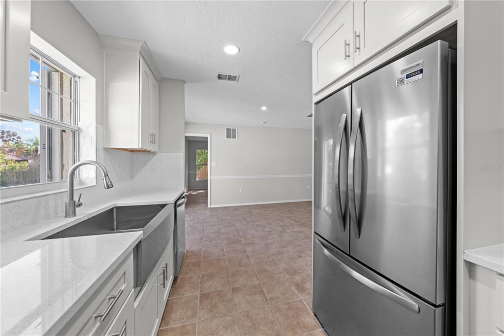 750 West New Nolte Road St. Cloud, FL 34769 - Photo 38 of 59 a kitchen with stainless steel appliances granite countertop a refrigerator and a sink