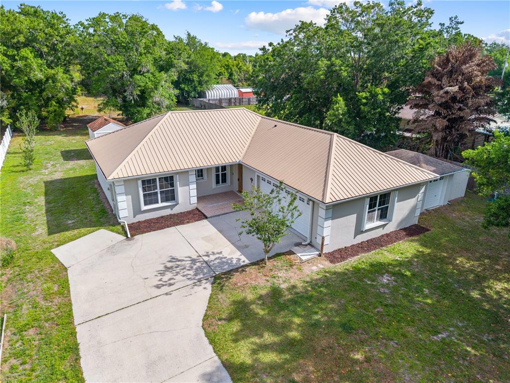 750 West New Nolte Road St. Cloud, FL 34769 - Photo 4 of 59 aerial view of a house with a yard balcony and mountain view in back
