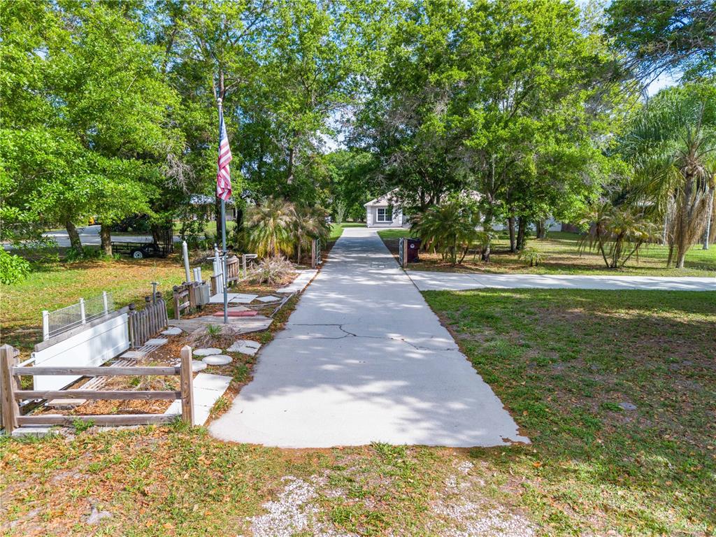 750 West New Nolte Road St. Cloud, FL 34769 - Photo 58 of 59 a view of a yard with plants and trees beside of it