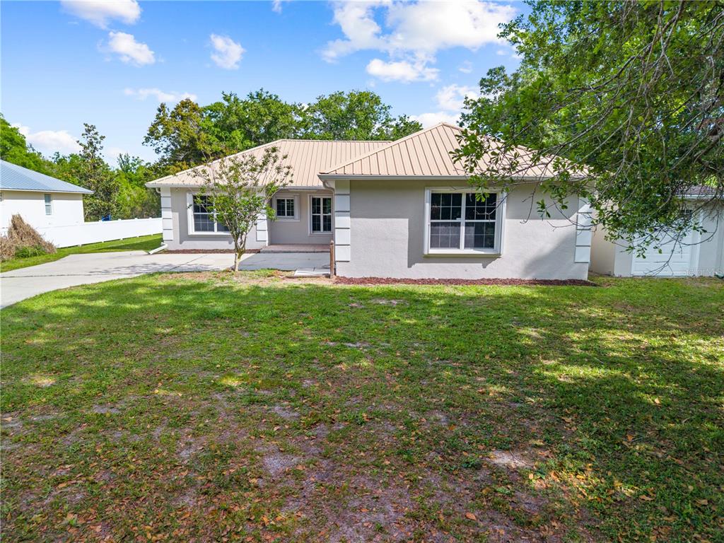 750 West New Nolte Road St. Cloud, FL 34769 - Photo 59 of 59 a front view of a house with a garden and yard