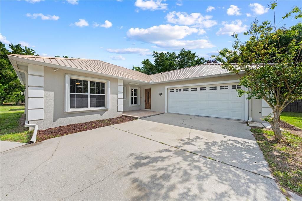750 West New Nolte Road St. Cloud, FL 34769 - Photo 6 of 59 a front view of a house with a yard and garage