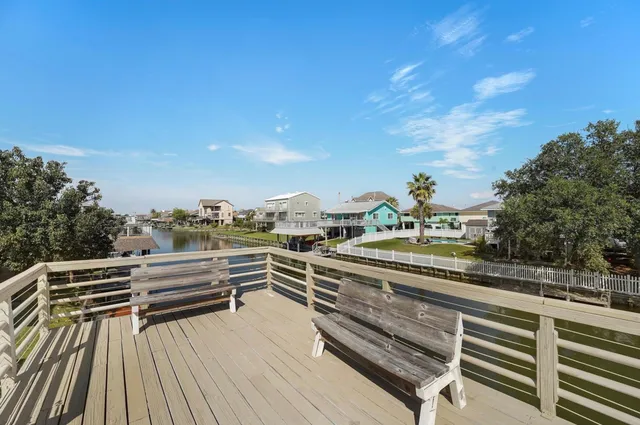 a view of a house with wooden deck