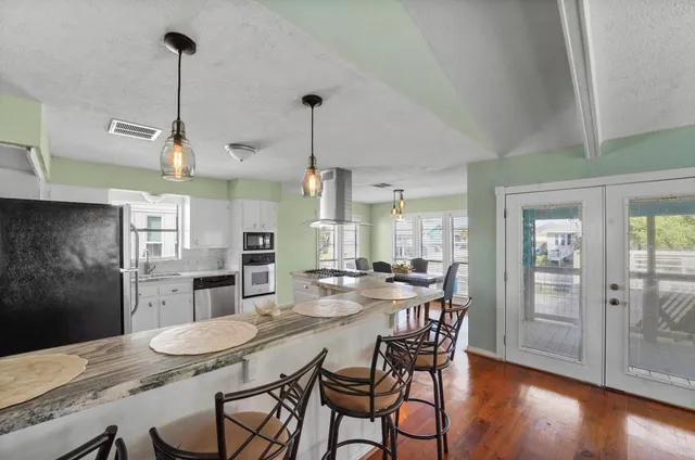a bedroom with furniture and a large window