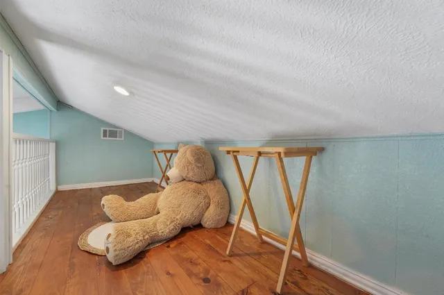 a kitchen with stainless steel appliances granite countertop a stove a refrigerator and a wooden cabinets