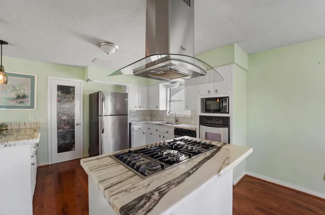 a kitchen with a dining table and chairs