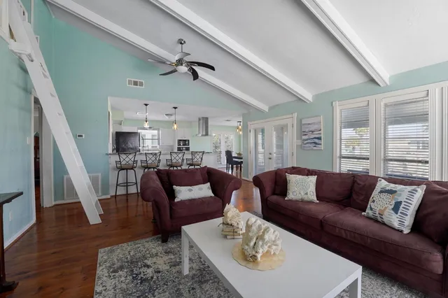 a bathroom with a granite countertop sink a toilet a mirror and bathtub