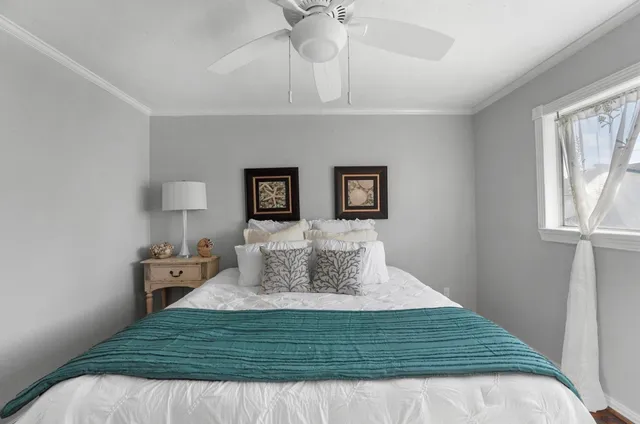 a bedroom with a bed and window