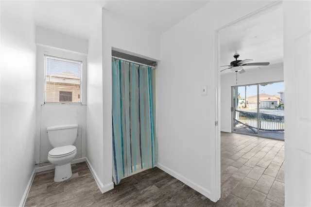 a view of a room with wooden floor and windows