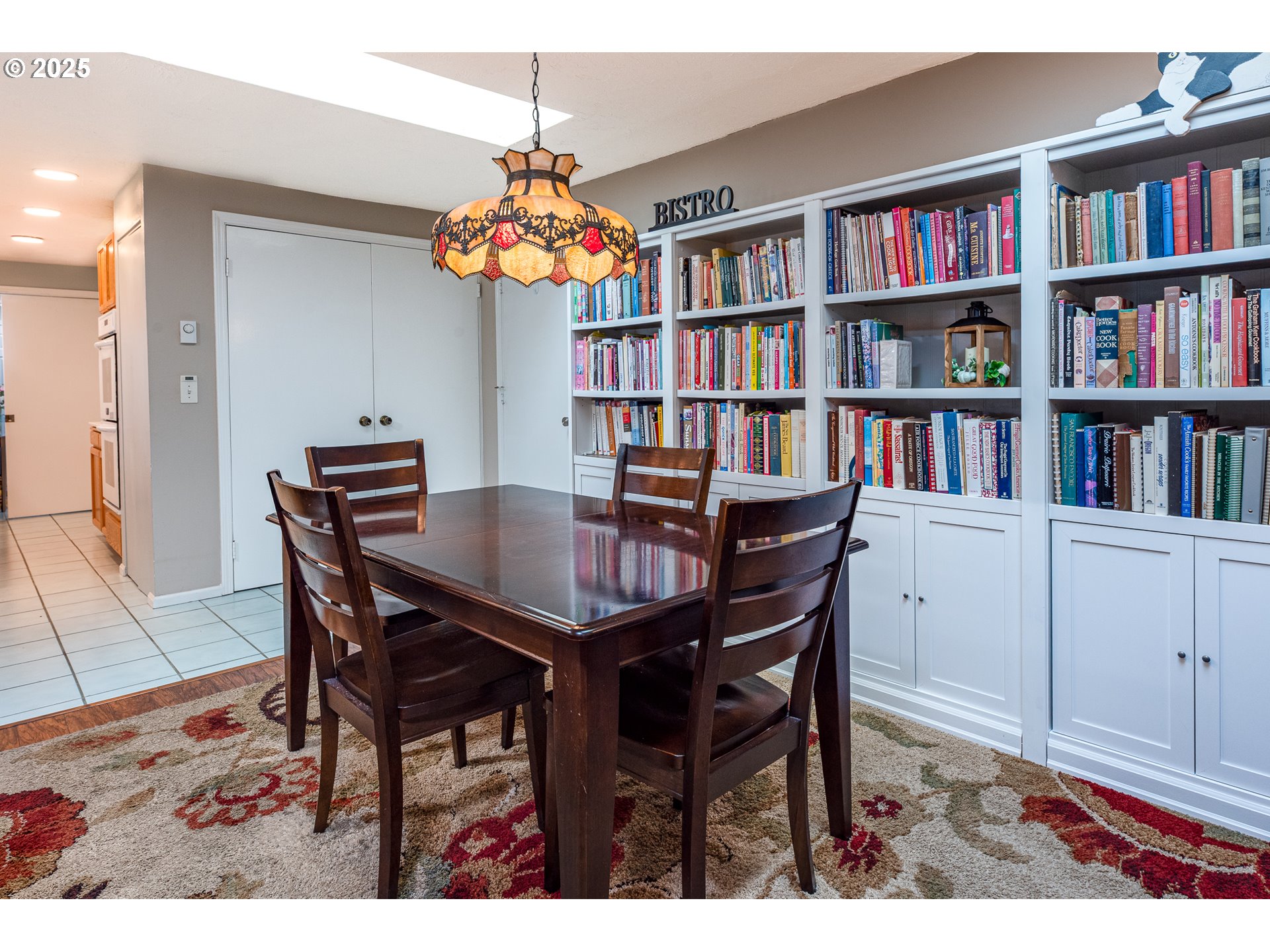 633 Rowan Avenue Springfield, OR 97477 - Photo 17 of 47 a view of a dining room with furniture and a book shelf