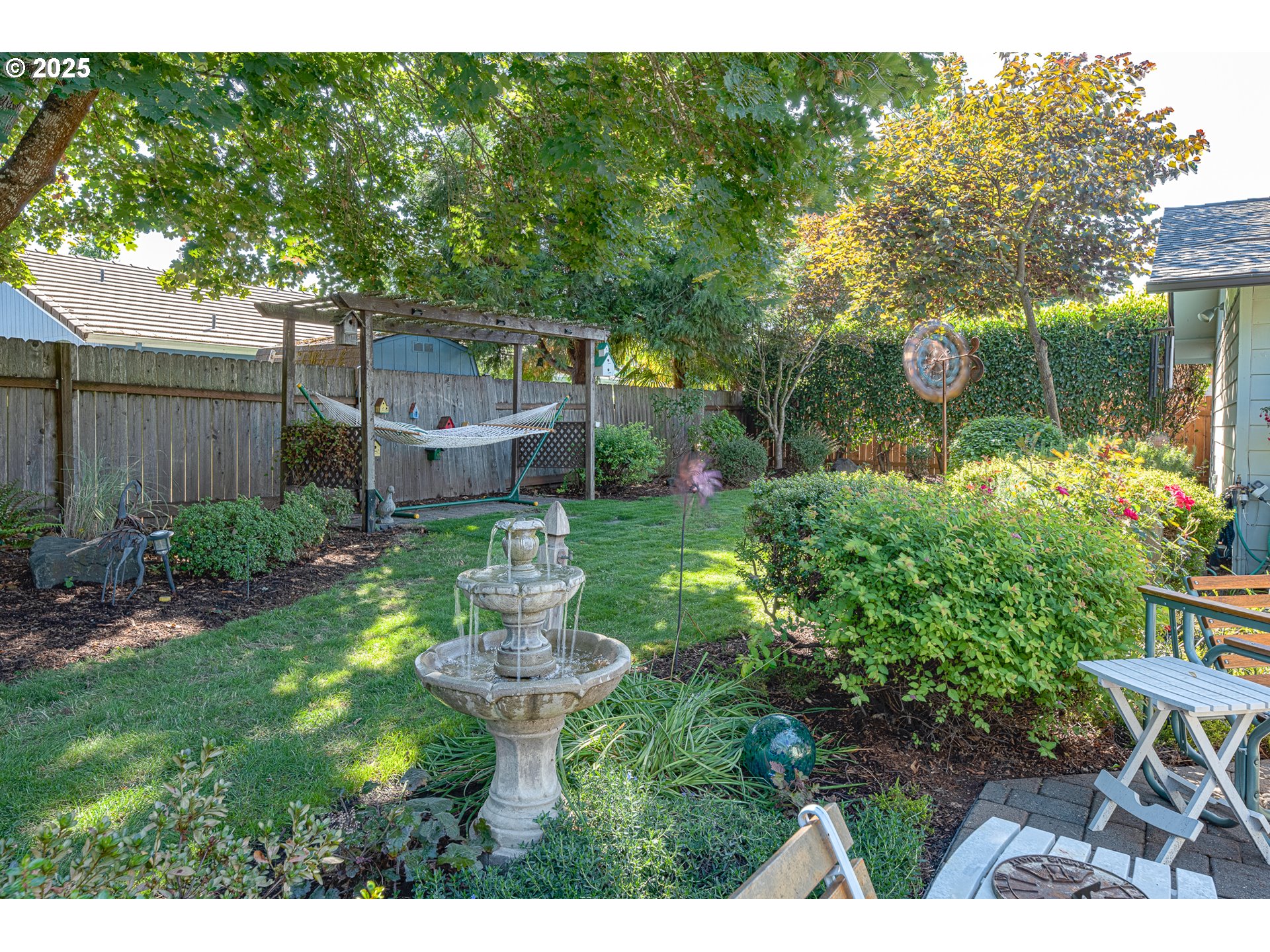 633 Rowan Avenue Springfield, OR 97477 - Photo 41 of 47 a view of a garden with a bench in patio