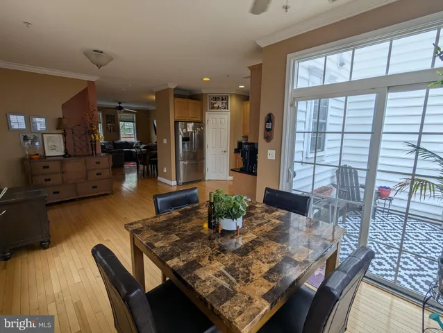 a dining room with furniture and wooden floor