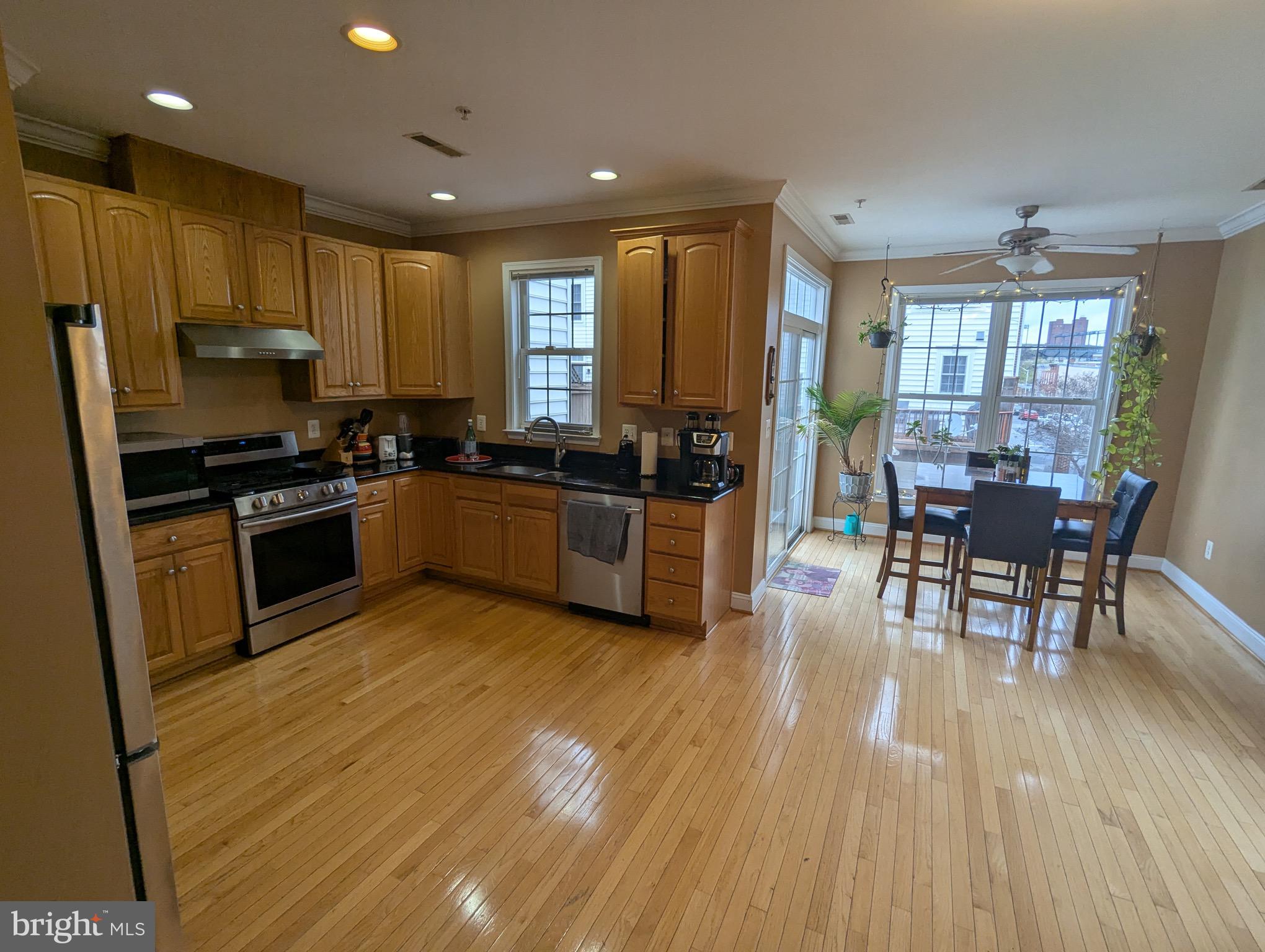 810 Ramsay Street Baltimore, MD 21230 - Photo 23 of 61 a kitchen with stainless steel appliances a stove a sink a oven a dining table and chairs