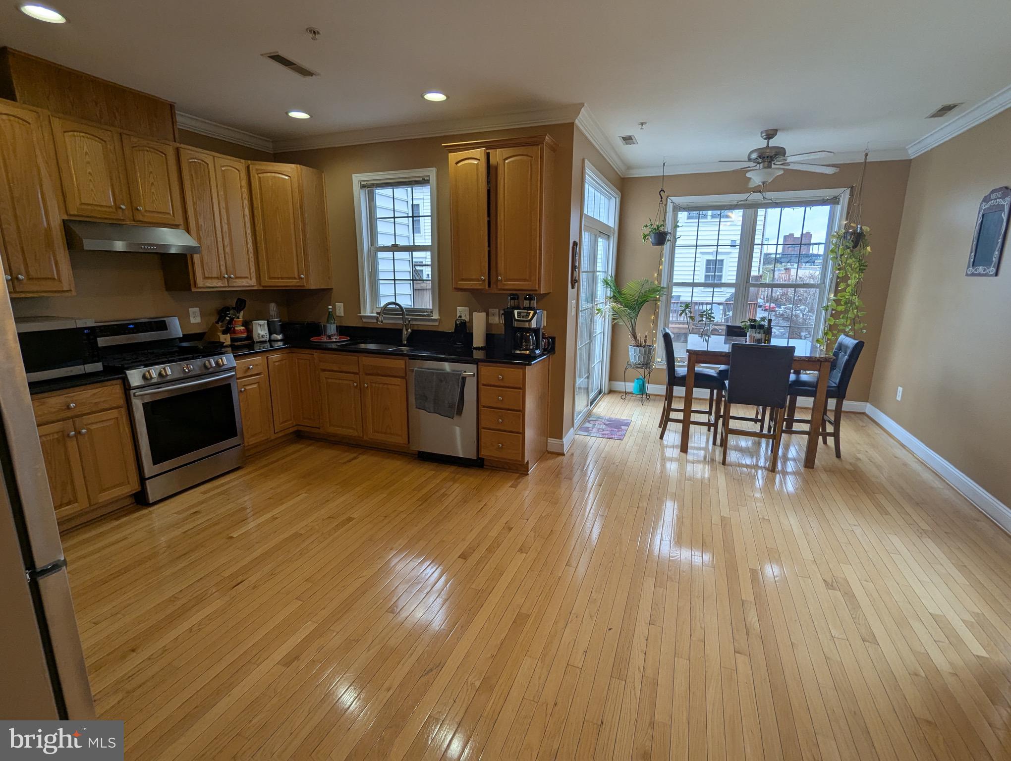 810 Ramsay Street Baltimore, MD 21230 - Photo 24 of 61 a kitchen with wooden floors and wooden cabinets