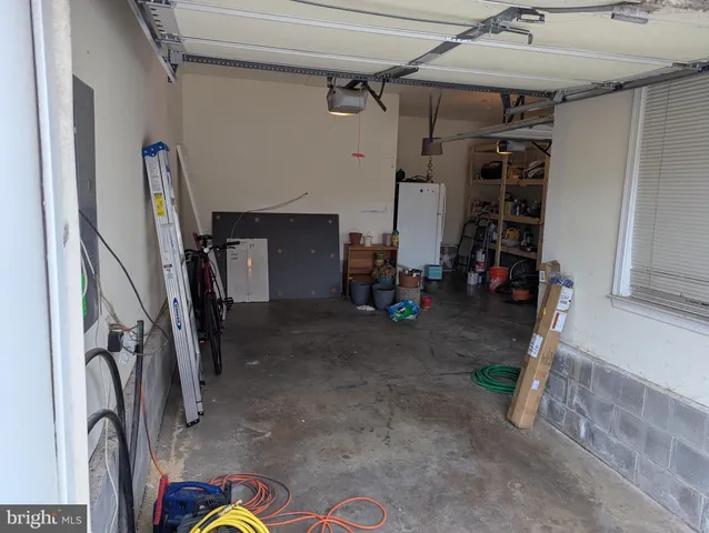 a bedroom with a bed and a lamp with wooden floor