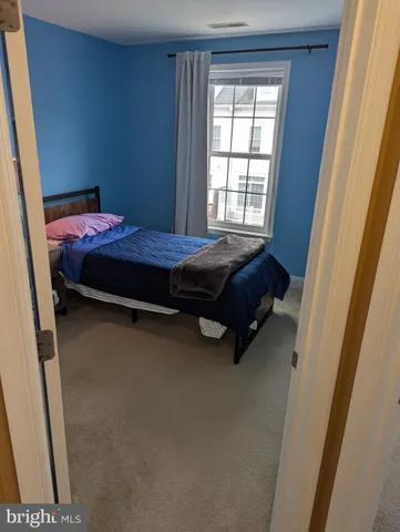 a bedroom with a bed and a lamp