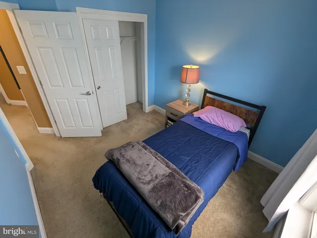 a bedroom with a bed dresser and a window