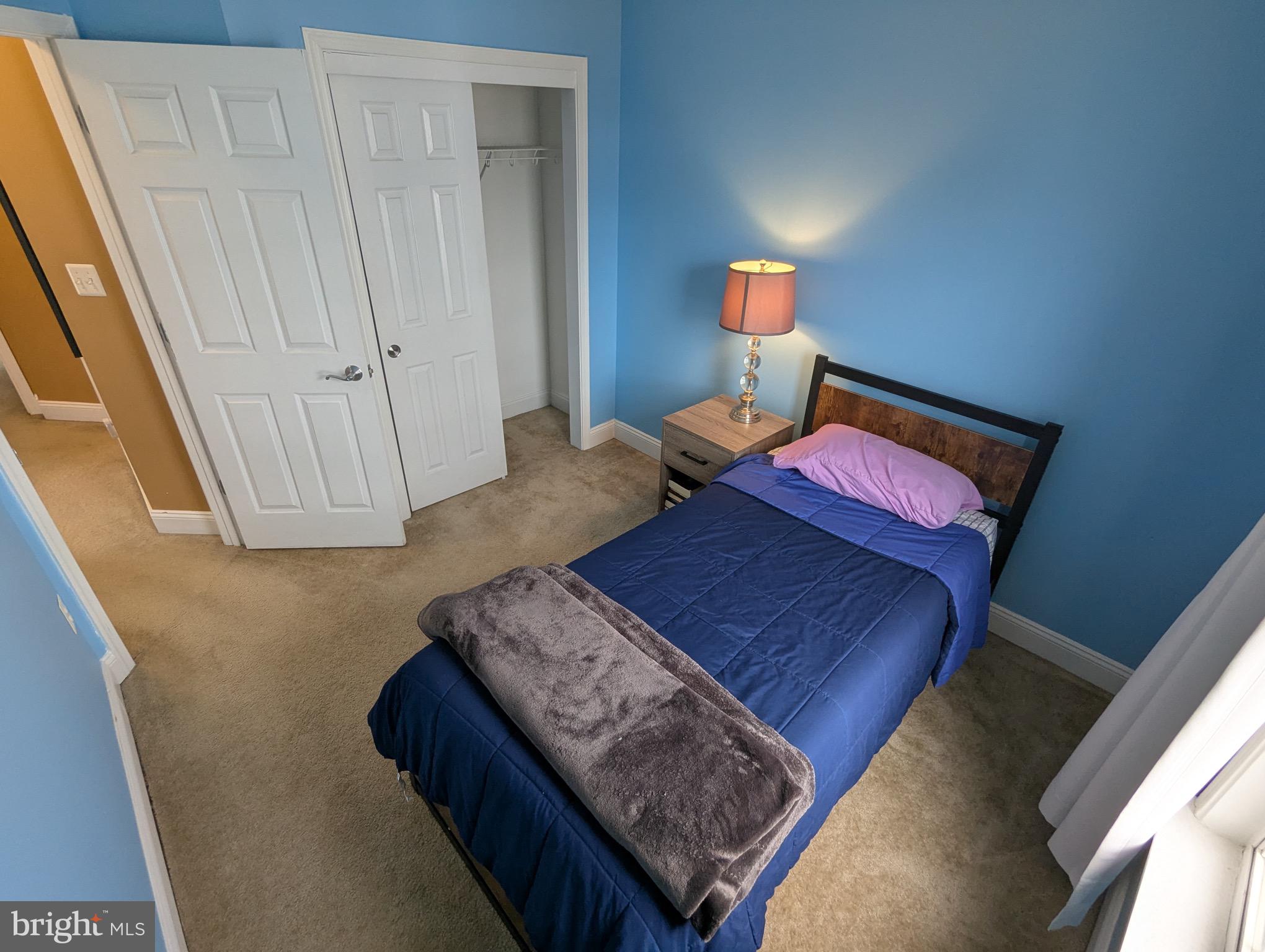 810 Ramsay Street Baltimore, MD 21230 - Photo 35 of 61 a bedroom with a bed and a lamp with wooden floor