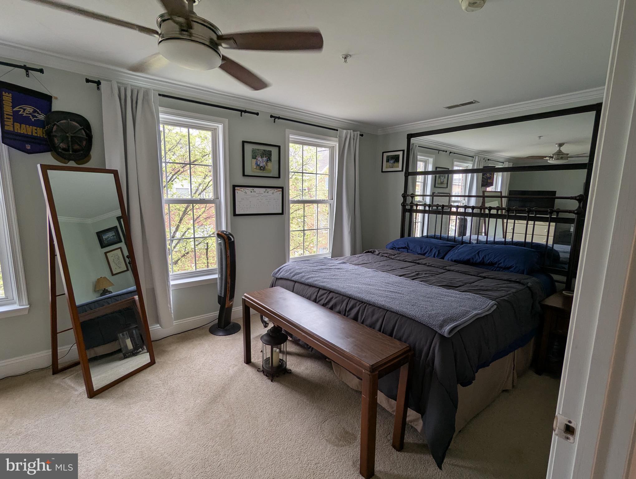 810 Ramsay Street Baltimore, MD 21230 - Photo 46 of 61 a bedroom with a bed a mirror on dresser and a window